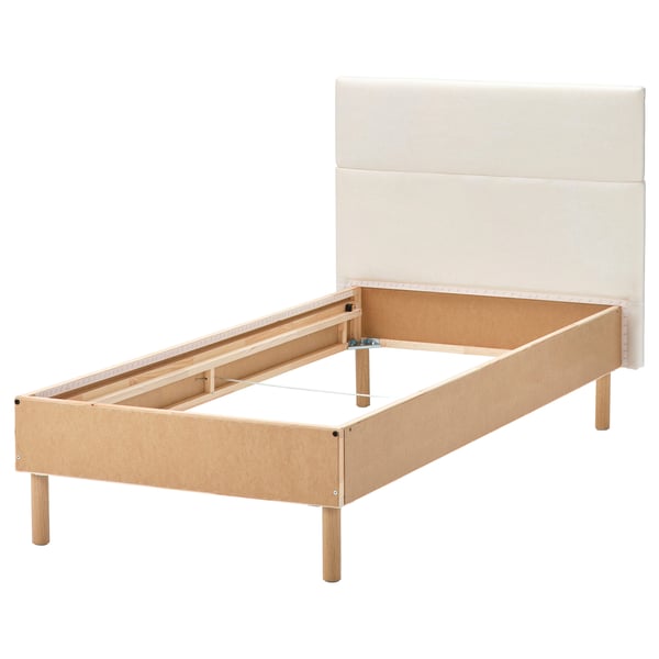 Modern light wood bed frame with beige headboard. Simple, clean design.