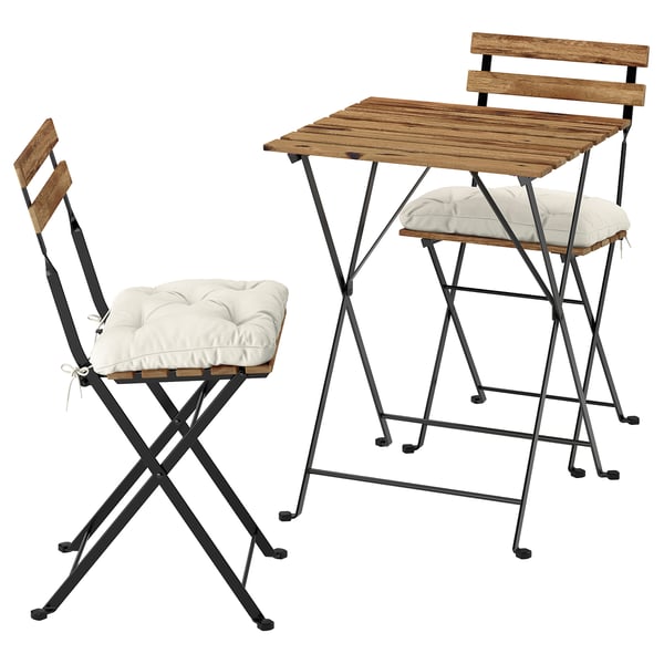 The TÄRNÖ outdoor set includes a wooden table and two chairs with metal frames and beige cushions.