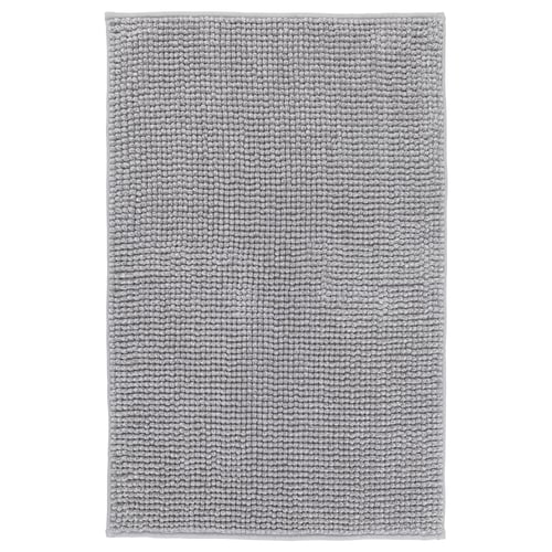 A grey TOFTBO bath mat, rectangular, with a soft, textured design. It is made from recycled polyester.