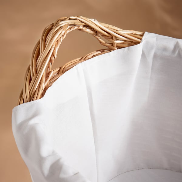 Handwoven willow laundry basket with white inner bag. Rustic, sturdy, and eco-friendly.