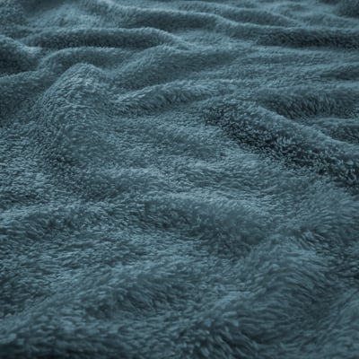 Close-up of soft, plush blue blanket with visible texture, highlighting its cosy and warm material.