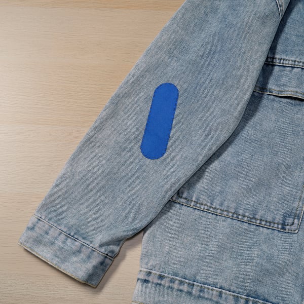 Grey fabric repair kit includes small scissors, pins, threads, and patches. Blue patch seen on grey cloth, indicating easy repair process.