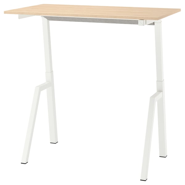 A trotton white adjustable height table with a light wooden top and metal legs.