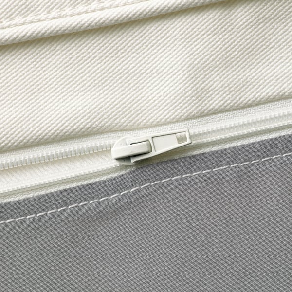 Close-up of a high-quality zip on a cotton fabric, showcasing precise stitching and durable materials.
