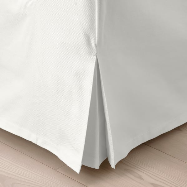 Crisp, white bed skirt with neat pleats, fit for clean, minimalist decor.