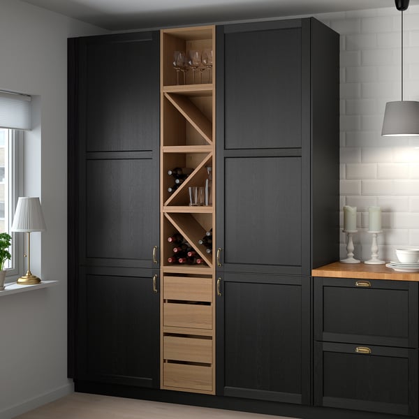 Modern kitchen with tall black & wooden cabinet. Holds glasses, bottles, & crockery. Tall, sleek design excludes window.