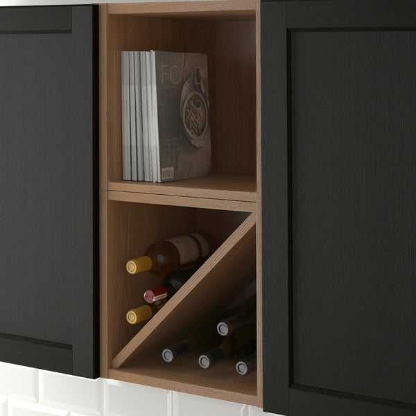 Built-in wine rack with stack of cookbooks. Stores and displays bottles neatly in kitchen cabinet.