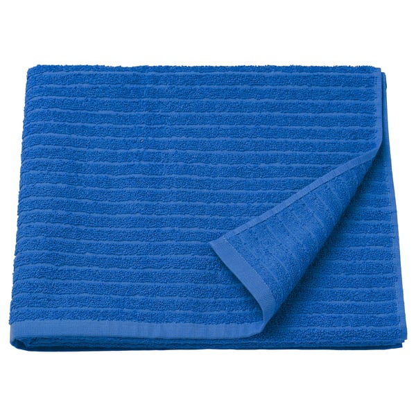 Folded blue VÅGSJÖN towel, soft cotton, ribbed texture.