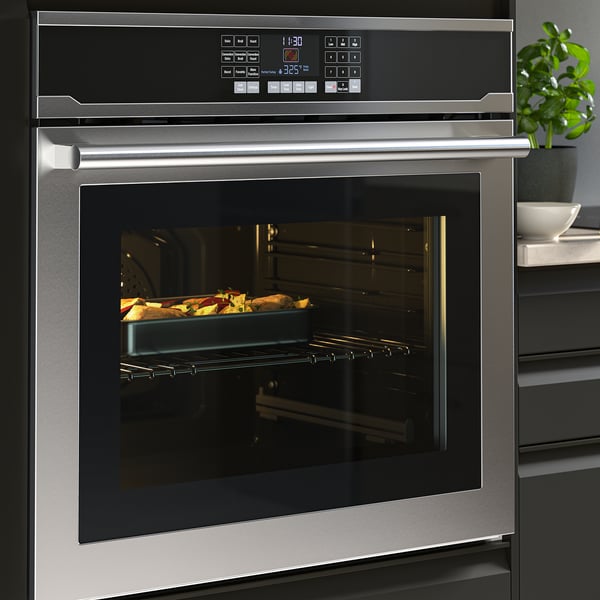 Stainless steel oven with digital display and self-cleaning function, baking tray inside.