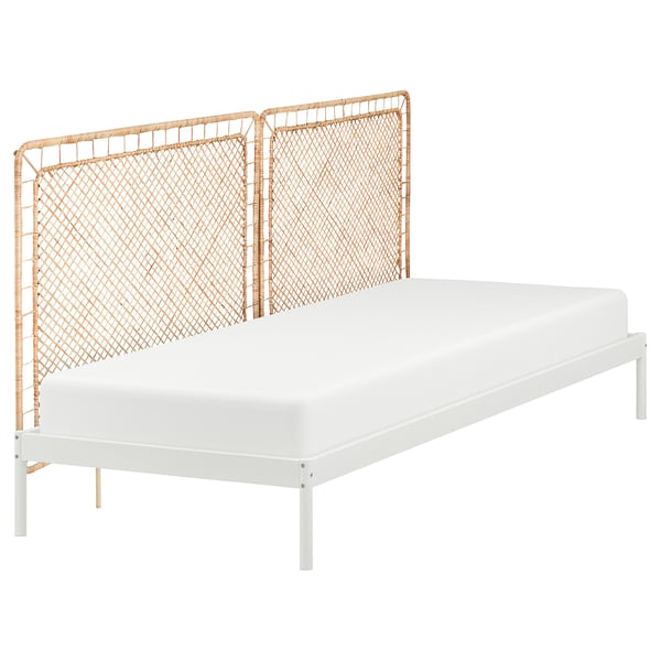 A VEVELSTAD bed frame with a white metal base and natural rattan headboard, combining modern and natural styles.
