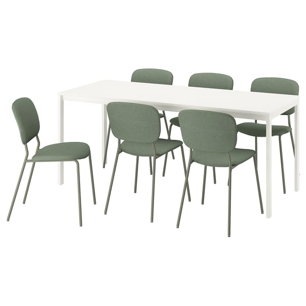 Modern white extendable dining table with six green chairs, sleek design.