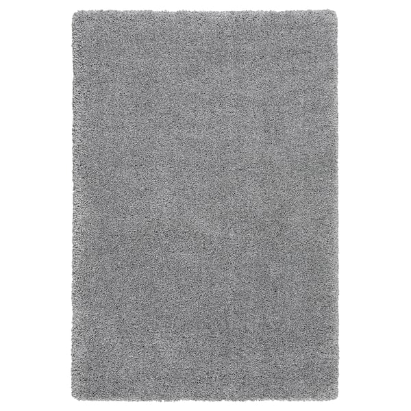 A grey shaggy area rug named VOLLERSLEV, made from recycled polyester and polypropylene, rectangular and soft-textured.