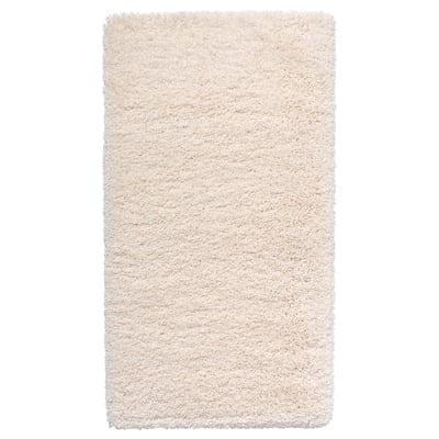 This is an a white, shaggy area rug with varying textures. Its rectangular and made from polypropylene.
