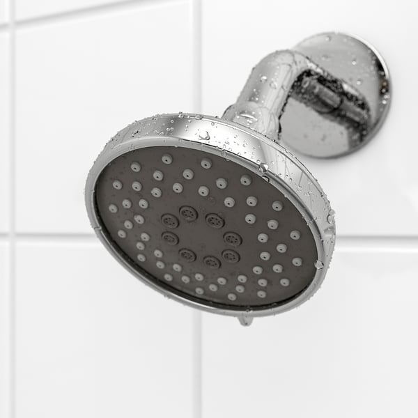 A shower head with numerous small holes for strong water flow, attached to a chrome wall bracket, reflecting quality and durability.