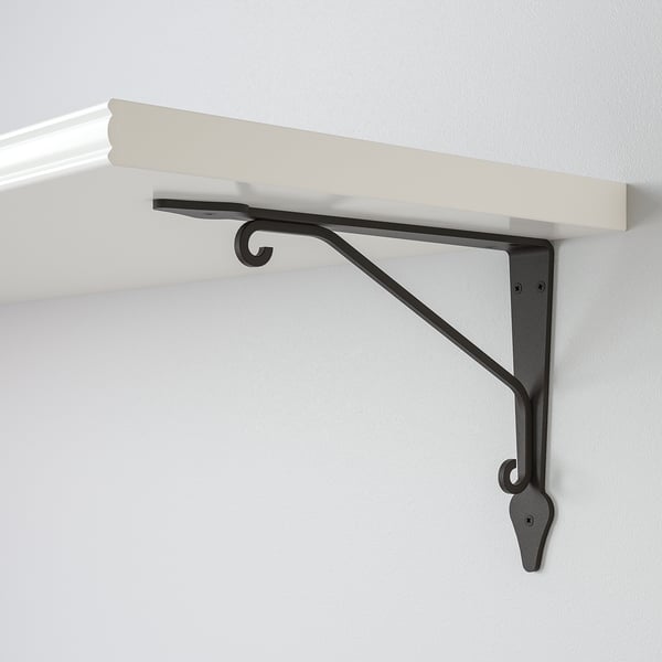 Wall-mounted shelf with metal bracket, securely attached to white wall. Modern design, high quality materials.