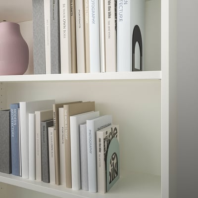 White bookshelf with colourful bookends and decorative items.