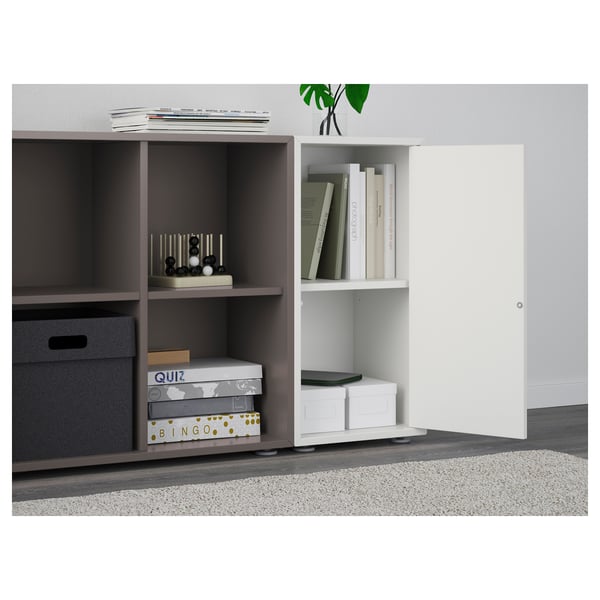 Modern bookcase with open & closed storage, holding games & books for display & organisation.