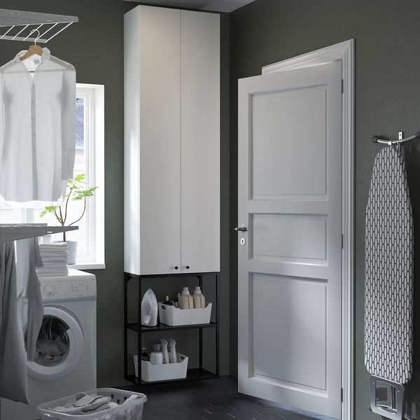 Organised laundry room with ENHET storage. Washer, dryer, and hanging garments. Efficient wall space usage.