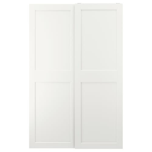 This image white GRIMO sliding closet doors. They have a clean, modern design with bold frames and bevelled edges, offering a minimalist look.
