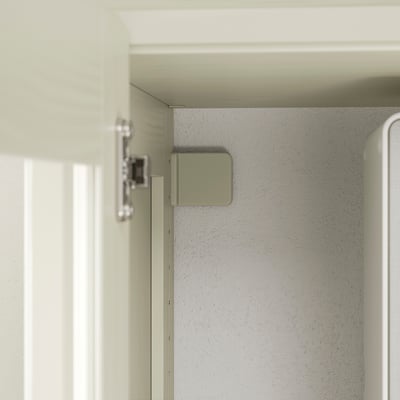 Close-up of a high-quality cabinet hinge, showing precise fitting and sleek design, indicative of durable craftsmanship.