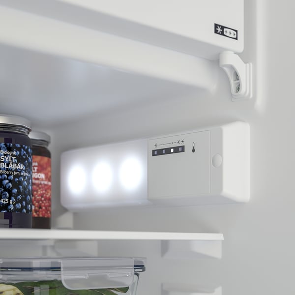Fridge interior with adjustable shelves, led light on, blueberry jam jar visible.