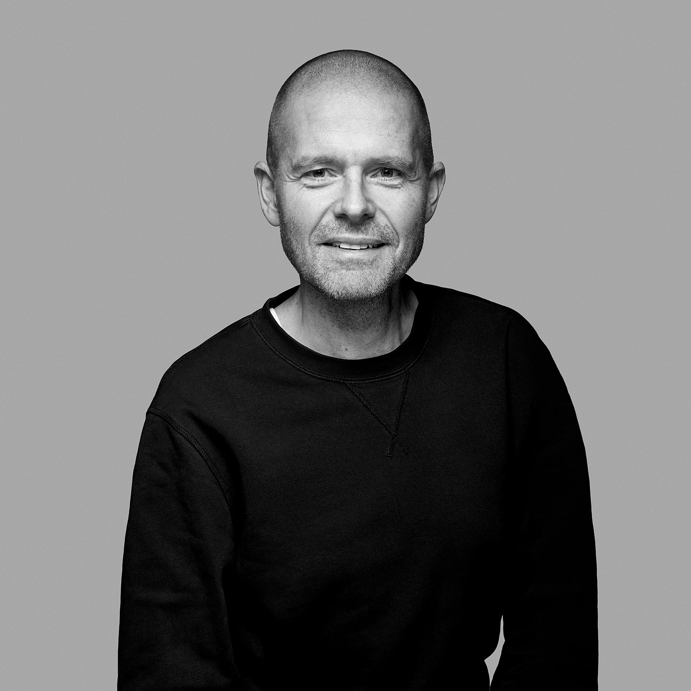 Black and white portrait of the designer wearing a dark sweater.