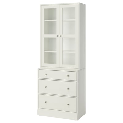 White HAVSTA set: glass cabinet, pine chest with metal handles.