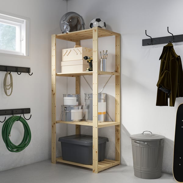 HEJNE wood shelf with boxes against wall.