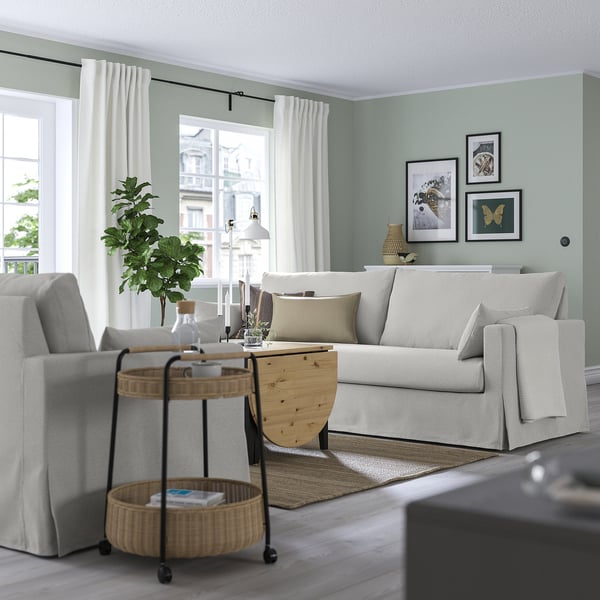 Living room with HYLTARP sofa, windows, side table, green walls, art