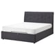 Dark grey upholstered bed with tufted headboard and white mattress.