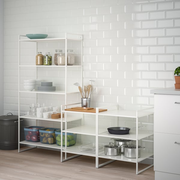 JONAXEL white storage shelves organise kitchen items, fitting neatly beside cabinets, with clear glass and sturdy metal frame.