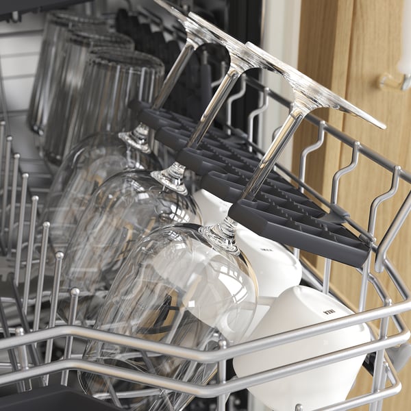 Open dishwasher showing glasses and utensil rack.