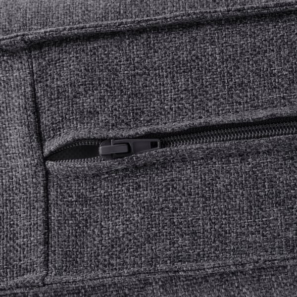 A close-up of a cosy, dark grey sofa with a durable, textured fabric and a functional, zipped armrest pocket showcasing quality design.