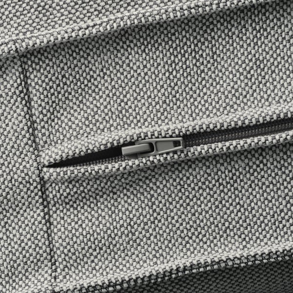 Close-up of a zip on a textured, tweed-like sofa cover, highlighting its high-quality fabric and durable design.