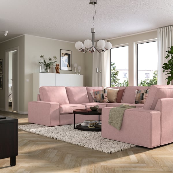 Modern living room with KIVIK sectional sofa, chandelier, coffee table, and large windows.