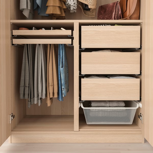 Organised closet with clothing sections, drawers, and storage bins.