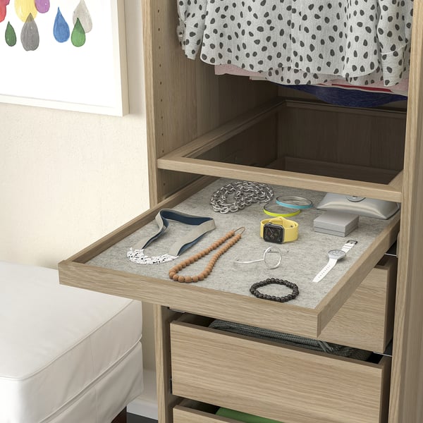 Open wooden drawer with accessories tray, jewellery, and watches neatly arranged on grey felt mat.