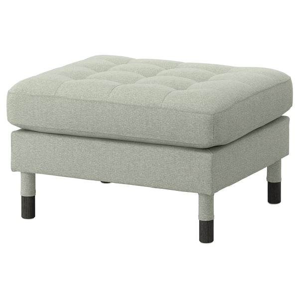The LANDSKRONA footstool in light grey fabric with a tufted top, four wooden legs.