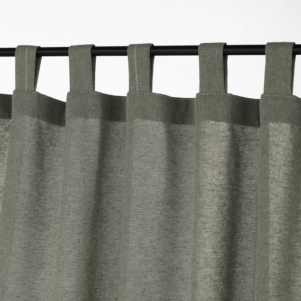 Grey cotton tab top curtains hanging on a black rod, providing privacy and light control.