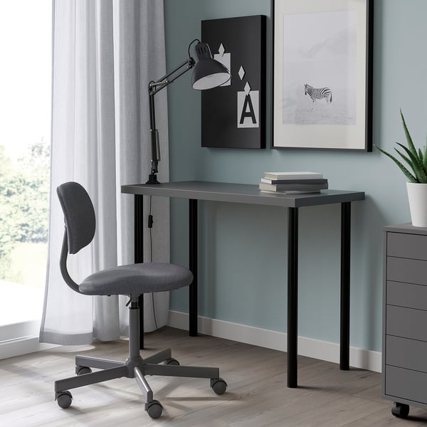 LINNMON desk with grey top, black lamp, art, and plant.