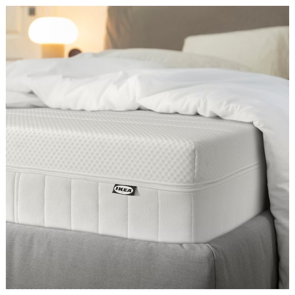 Ikea MAJSKÄR foam mattress with remote control for adjusting head angle, shown in white.