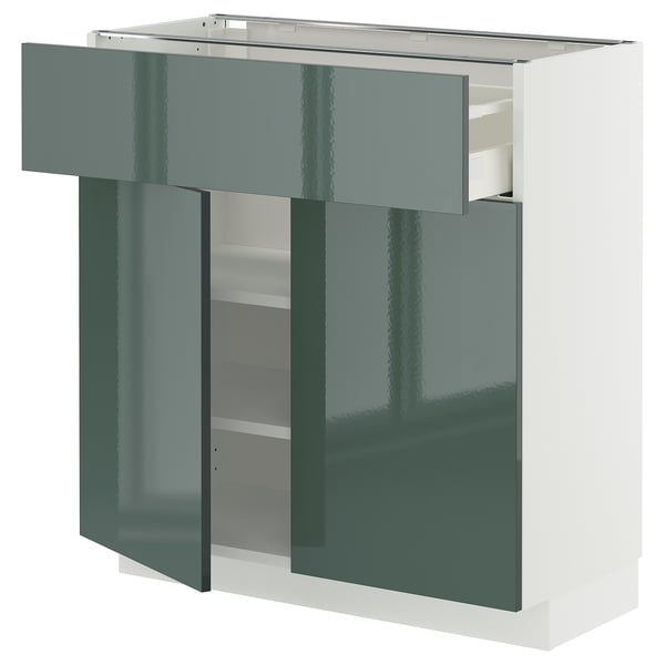 Modern kitchen unit, white and green. Drawers and shelves. Sleek, glossy finish.