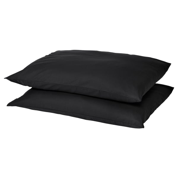 Two black square pillows stacked, smooth dark fabric, simple design.