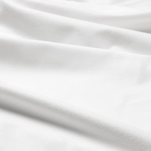 Close-up of soft, textured cotton fabric, likely NORDRUTA bedding, showcasing its smooth and inviting surface.