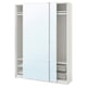 A white ikea PAX wardrobe with mirrored sliding doors, metal shelves, and mesh baskets.