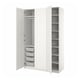 An open white PAX wardrobe with mesh drawers and shelves.