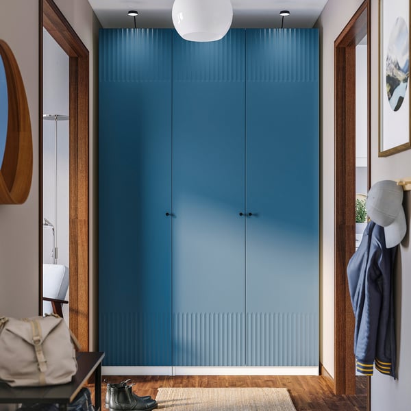 Blue PAX wardrobe with coat, bag, and light fixture.