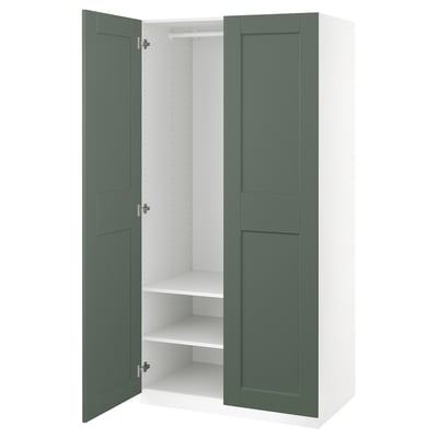 Open white PAX wardrobe with green doors, showing shelves and hanging rail.