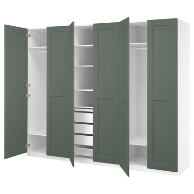 An open green PAX wardrobe with white shelves and partitions, displaying organised storage spaces.