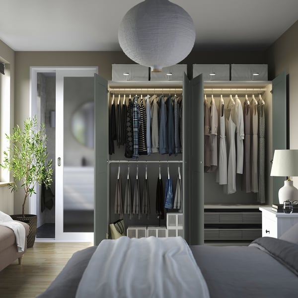 PAX closet with clothes, coats, lit shelves, adjustable interiors.